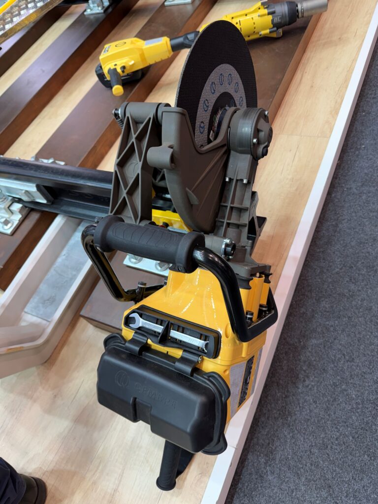 View from above of the Cembre battery rail saw showing its cutting disc, guard, handles and onboard wrench storage